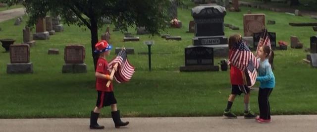 Children Placing American Flags in Cemetery