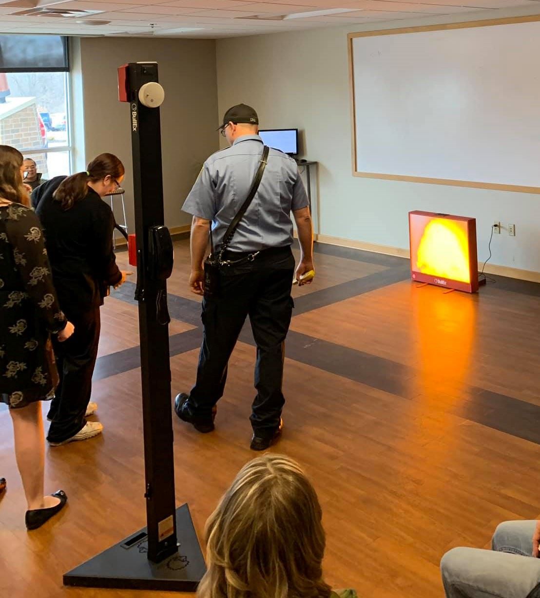 Person extinguishing simulated fire