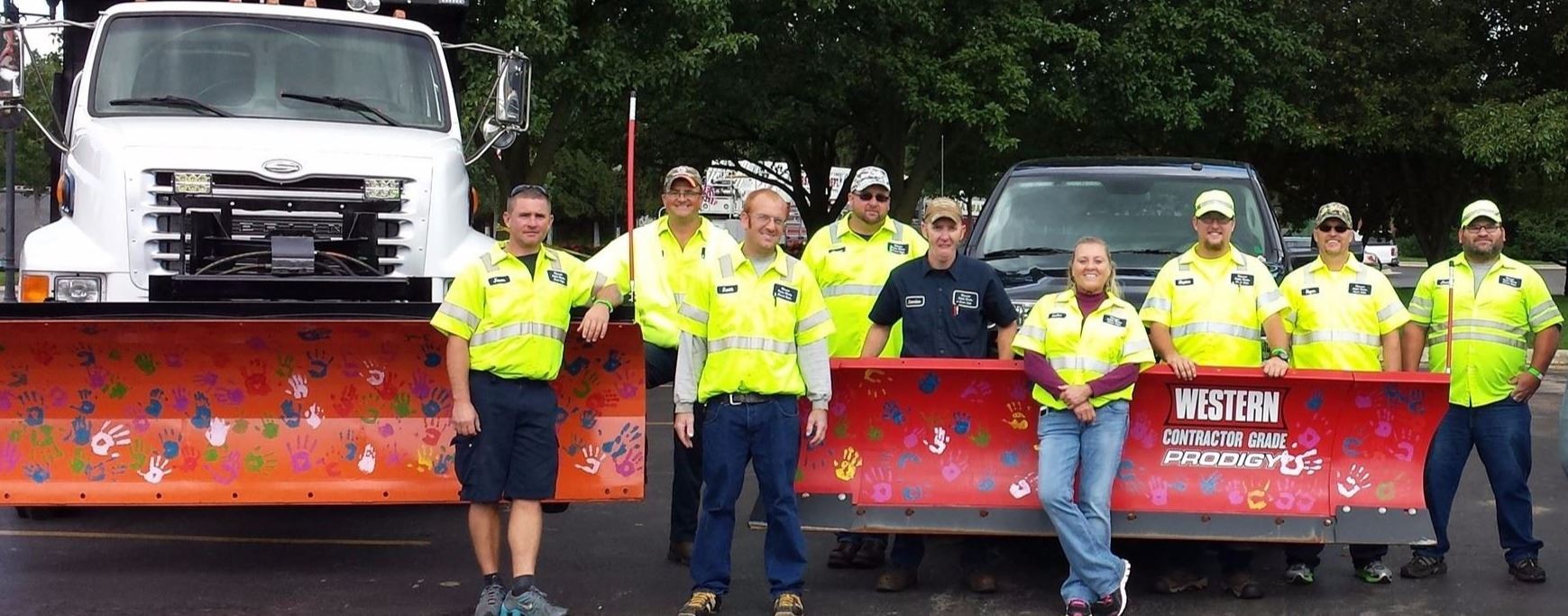 Public Works Employees in Front of Plows